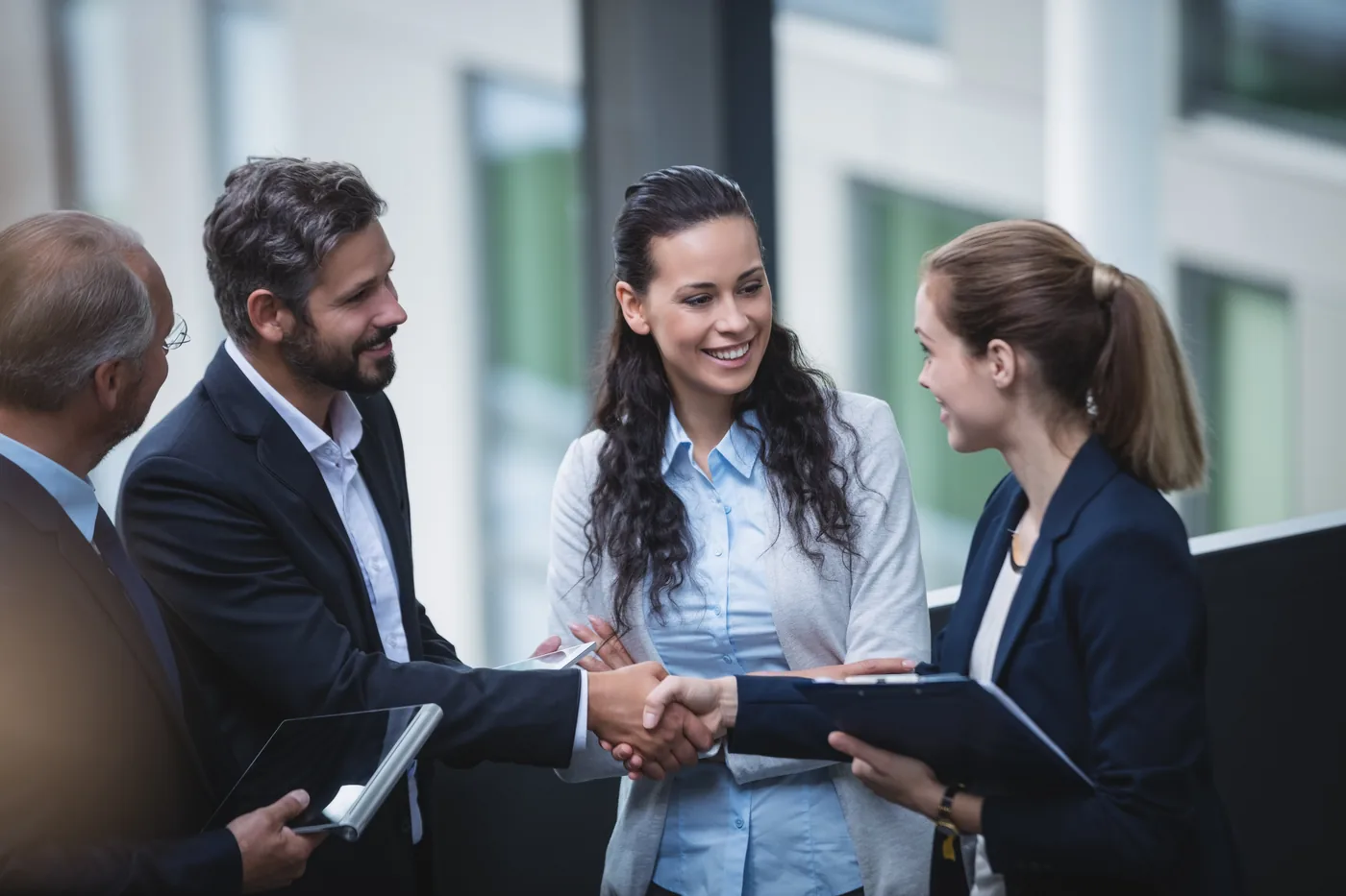 Job seeker shaking hands with a hiring team member during an in-person meeting